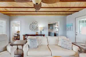 a living room with a couch and a table at Moonlighting in Edisto Beach