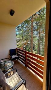 a screened in porch with a view of the trees at Apartman Silver Lux in Zlatibor