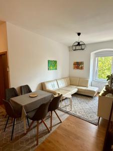 a living room with a couch and a table at Lorume in Postojna