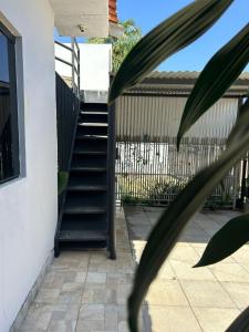 a stairway leading up to a house at Apartamento Central in Primavera do Leste