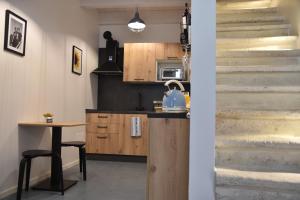 a kitchen with stairs and a table with a kettle on it at Sistò Petite Maison in Altamura +15 photos