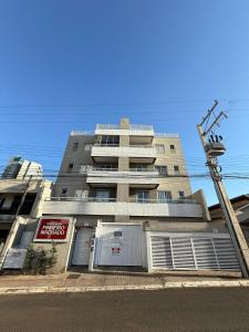a tall building with two garage doors in front of it at Studio Charmoso Próximo ao Parque do Lago - SPMA01 in Guarapuava