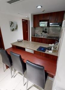 a kitchen with a counter with chairs around it at River view6 in Guayaquil