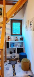 a room with a staircase with a table and a window at CaSa ViTo Kumrovec 