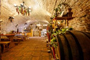 a wine cellar with a bunch of wine barrels at La Teo Pensiune si Pivnita in Sighişoara