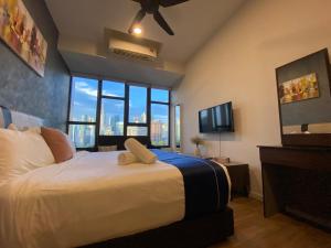 a bedroom with a large bed with a large window at Ceylonz Suites by Stayla in Kuala Lumpur +88 photos