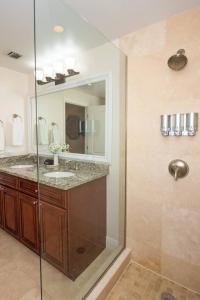 a bathroom with a glass shower and a sink at Windsong #2 Beautiful Boggy Sand Beach, Smb in West Bay