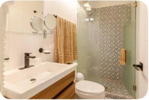 a bathroom with a sink and a toilet and a shower at LA HIDALGO Departamento 3 in Chapala +10 photos