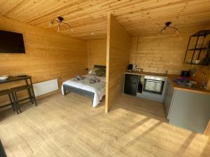 a small room with a bed and a kitchen at Executive Cabin and Jacuzzi 2 in Monaughrun Cross Roads