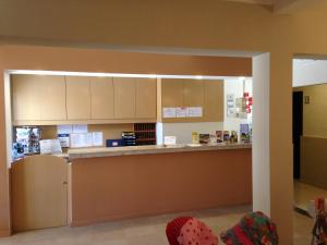 a kitchen with white cabinets and a counter at Vilamar in Luz