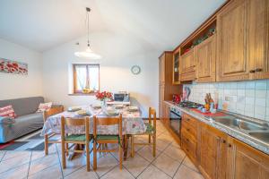 a kitchen with a table with chairs and a couch at La Rosa Bianca in Morbegno +37 photos