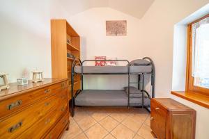 a bedroom with a bunk bed and a dresser at La Rosa Bianca in Morbegno