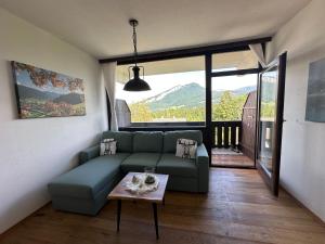 a living room with a couch and a table at Steinbock Apartement in Bad Goisern