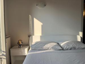 a white bedroom with a bed and a white wall at Casa Dell'Era in Treviglio +15 photos