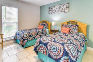a bedroom with two beds and a window at 4 Mi to Siesta Key Beach Condo with Pool Access in Sarasota +21 photos