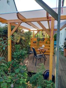 a wooden patio with a table and a bench at Ferienwohnung Lojane in Kranenburg