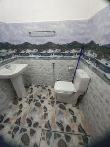 a bathroom with a white toilet and a sink at New Forest Glen Nest in Ella +79 photos