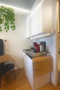 a kitchen with white cabinets and a red appliance on a counter at Professor Dahls Gate 16 in Oslo