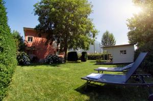 a chair and a hammock in a yard at APPARTAMENTO i Sentieri in Dro