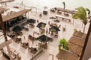 an overhead view of a restaurant with tables and umbrellas at AWA Holbox Hotel Boutique - Beach Front in Holbox Island