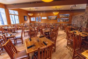 a dining room with wooden tables and chairs at Zion Lodge - Inside the Park in Springdale