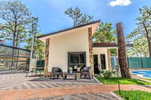 a patio with chairs and a table next to a house at Bungalos Vista a Cayaguanca in San Ignacio