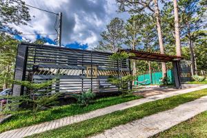 a park bench sitting in the grass next to a sidewalk at Bungalos Vista a Cayaguanca in San Ignacio