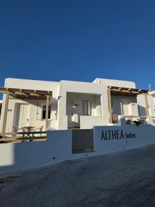 a white house with a sign in front of it at ALTHEA suites in Naousa