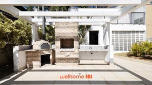 a patio with an outdoor fireplace in a house at Studio em Cotia com piscina e lazer completo in Cotia