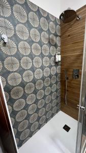 a bathroom with a shower with a wall at Anemoi in Agropoli +19 photos