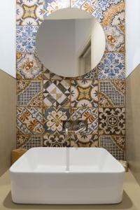 a bathroom with a white sink and a mirror at Bed and Breakfast Nilu' in Castellammare del Golfo +40 photos