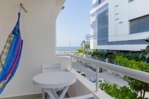 a balcony with a white table and a view of a street at New Pueblito Suites - Cerca a la Playa in Cartagena de Indias