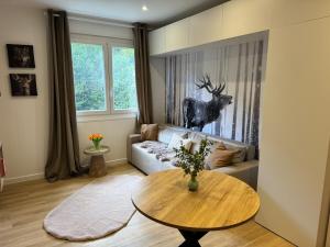 a living room with a couch and a table at Studio le Grand Cerf in Les Angles