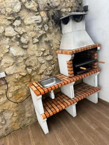 a toilet sitting on a bench in front of a stone wall at Casa Rosa in Setúbal +39 photos