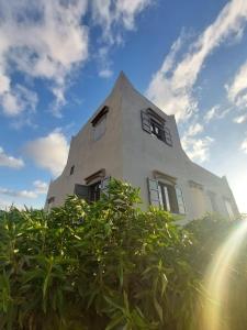 a white building with windows on the side of it at Villa Chaima in Essaouira region in Essaouira +17 photos