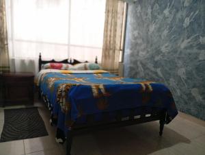 Ένα ή περισσότερα κρεβάτια σε δωμάτιο στο hospedaje dorado engativá