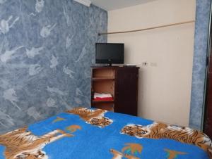 Ένα ή περισσότερα κρεβάτια σε δωμάτιο στο hospedaje dorado engativá