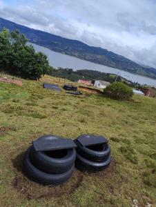 two tires laying on the grass in a field at Zona de camping zoe in Guatavita