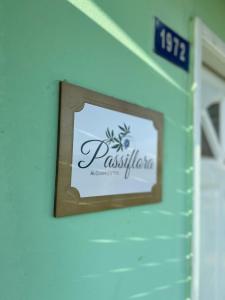 a sign for a restaurant on a wall at Casa Passiflora II in Villa Elisa