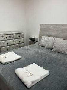a bedroom with a bed with two towels on it at Casa Passiflora II in Villa Elisa