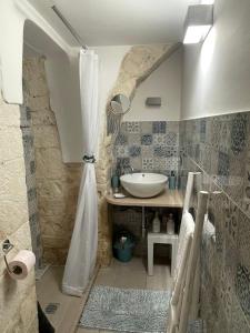 a bathroom with a sink and a shower at Casa Giulia in Martina Franca +19 photos