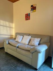 a couch sitting in a corner of a room at Casa Passiflora II in Villa Elisa