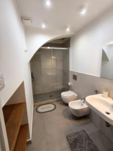 a bathroom with two toilets and a sink and a shower at Casa Ludovica in Catania