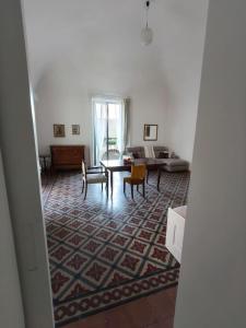 a living room with a couch and a table at Casa Ludovica in Catania