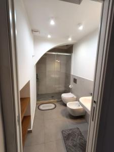 a bathroom with two toilets and a walk in shower at Casa Ludovica in Catania +29 photos