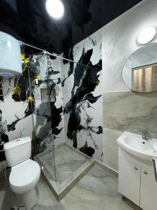 a bathroom with a toilet and a sink at PENSIUNEA Ana in Buftea +24 photos