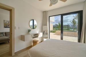 a bedroom with a bed and a mirror and a couch at Luxury Escape Private Jacuzzi, Beach, Punta Cana SLEEP 5 in Punta Cana +39 photos