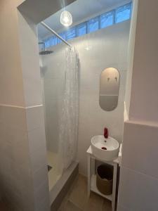 a white bathroom with a sink and a shower at La barraca del pescador in Denia +31 photos