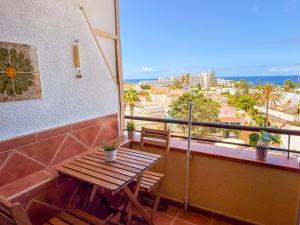 a balcony with a table and a view of the ocean at Piso los Agaves in Costa de Adeje +39 photos