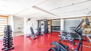 a gym with two treadmills and cardio machines at Studio em Cotia com piscina e academia in Cotia